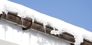 Ice dam with ice hanging from the gutter