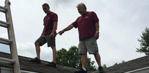 Jon and Mike inspecting a roof for leaks